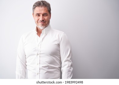 Business portrait - businessman smiling. Mature age, middle age, mid adult man in 50s with happy confident smile. Copy space.