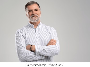 Business portrait of confident businessman. Entrepreneur in blue shirt, Senior adult, mature age man standing, isolated on white background. - Powered by Shutterstock