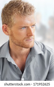 Business Portrait Of A Handsome Young Smart Man In Bright Office Setting