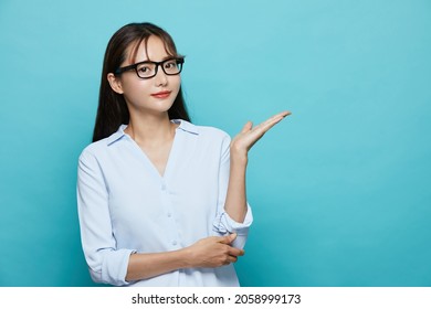 Business Portrait Of Young Asian Woman On Blue Background