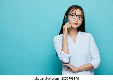 Business Portrait Of Young Asian Woman On Blue Background