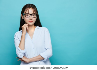 Business Portrait Of Young Asian Woman On Blue Background