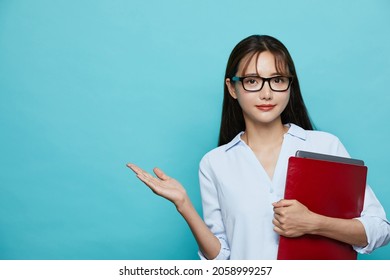 Business Portrait Of Young Asian Woman On Blue Background