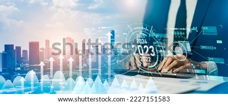 Business positive indicators in 2023 concept.Businessman analysis profitability of working companies with digital augmented reality.Business development to success and growing growth year 2022 to 2023