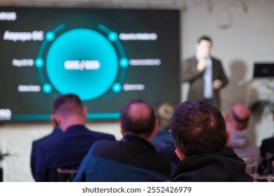 Business presentation with audience focusing on a digital visual display in a conference setting.