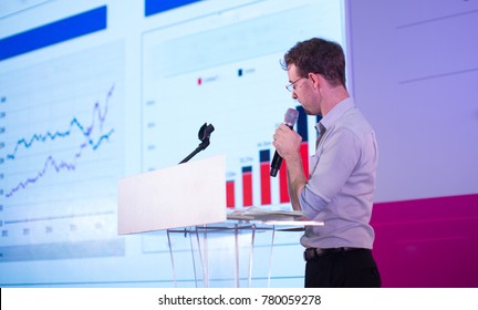 Business Presentation. Presenter Showing Charts and Graphs.