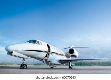 Business Private Jet Airplane On Airfield. Waiting A Passenger With Open Door. Business And Power Concept.