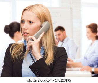 Business And Problems Concept - Confused Woman Arguing On The Phone Phone