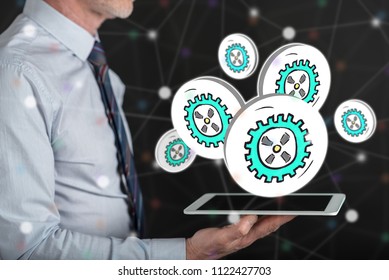 Business process concept above a tablet held by a man - Shutterstock ID 1122427703