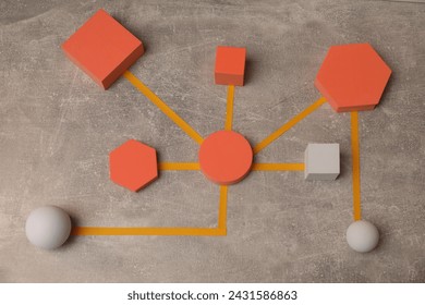 Business process organization and optimization. Scheme with geometric figures on grey table, above view