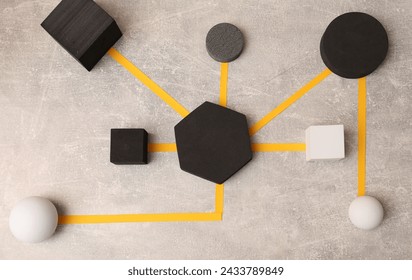 Business process organization and optimization. Scheme with geometric figures on light grey table, top view