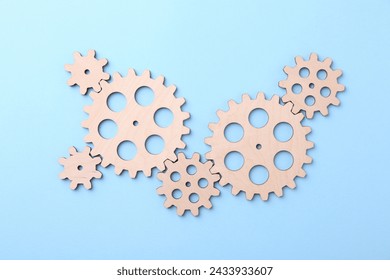 Business process organization and optimization. Scheme with wooden figures on light blue background, top view