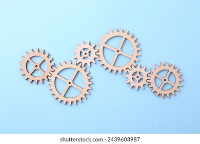 Business process organization and optimization. Scheme with wooden figures on light blue background, top view