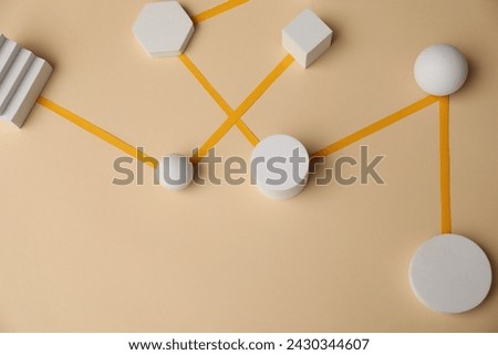 Business process organization and optimization. Scheme with geometric figures on beige background, above view