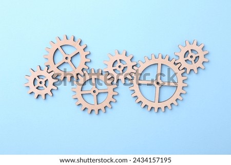 Business process organization and optimization. Scheme with wooden figures on light blue background, top view