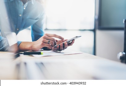 Business process photo. Account manager using mobile phone. Typing contemporary smartphone screen. Horizontal. Film effect. Blurred background - Powered by Shutterstock