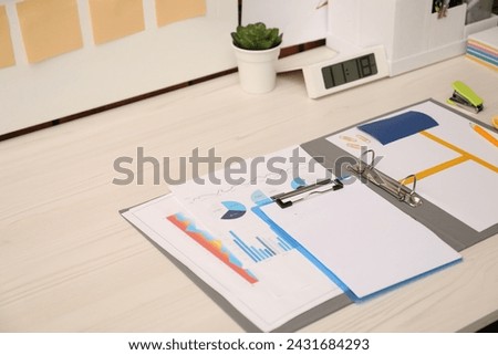 Business process planning and optimization. Documents with different types of graphs and stationery on wooden table