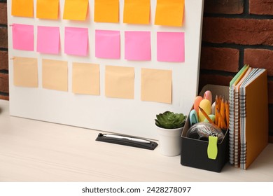 Business process planning and optimization. Workplace with colorful paper notes and other stationery on table