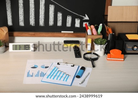 Business process planning and optimization. Workplace with different graphs and other stationery on wooden table