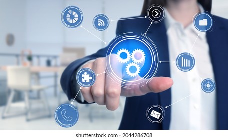 Business process. Woman touching virtual screen with different icons in office, closeup - Powered by Shutterstock