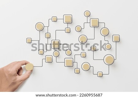 Business process and workflow automation with flowchart. Hand holding wooden cube block arranging processing management on white background