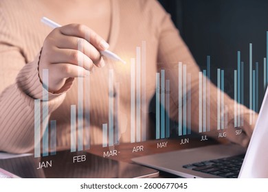 A business professional analysis financial growth using digital data visualization.Bar chart overlay with monthly performance trends, financial forecasting, and market insights. - Powered by Shutterstock - Get 15% off with code: PIKWIZARD15
