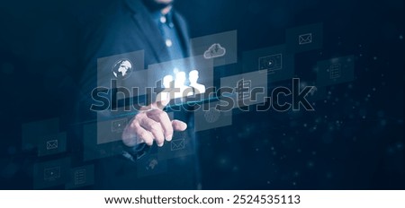 A business professional interacts with digital interface technology, showcasing innovation and teamwork in a modern work environment.