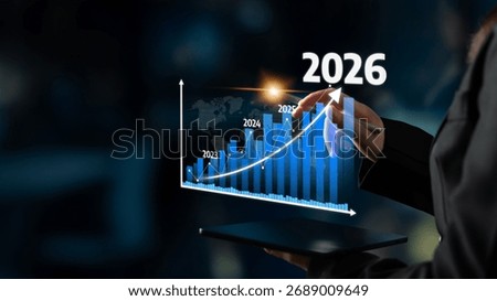 A business professional interacts with an interactive graph displaying growth projections from 2023 to 2026, showcasing trends and data analysis in a modern environment. Tessel