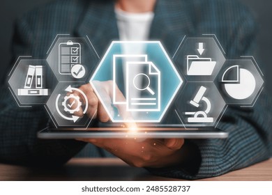 A business professional uses a tablet with futuristic interface icons representing data analysis, research, and documentation for a case study concept. - Powered by Shutterstock