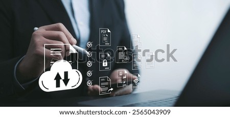Business professional using cloud-based tools for managing digital files on a laptop, showcasing advanced document handling and productivity solutions. Perfect for tech and efficiency themes