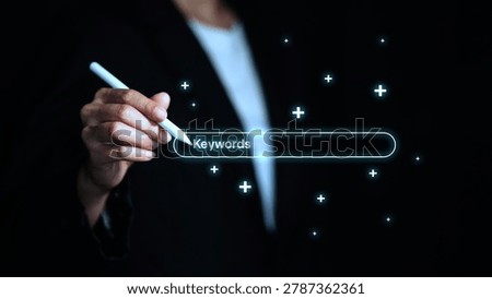 Business professional using digital interface for keyword research, SEO search optimization, content strategy and online marketing analysis with futuristic technology concept.