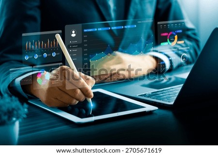 Business professional using digital tablet with stylus and data analytics dashboard, showing charts and graphs, representing financial analysis, business intelligence, big data, digital technology