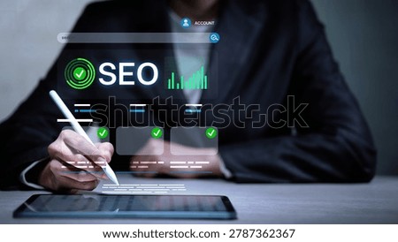 Business professional using digital tablet with SEO strategy dashboard, search engine optimization analytics, website performance tracking and online marketing interface.