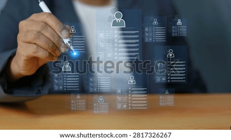 Business professional using digital technology to manage employee profiles, organize talent data, and streamline recruitment, human resources, workforce planning, and employee management through digital systems.