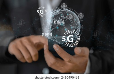 Business professional using smartphone with a holographic 5G network concept, digital globe with interconnected 5G symbols, 5G technology in modern business and communication, digital transformation - Powered by Shutterstock