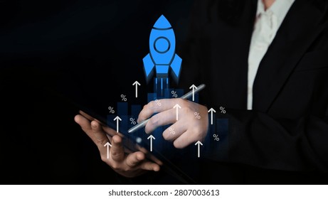 Business professional using tablet to launch project with rocket graphic representing growth and innovation in a digital environment