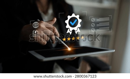 Business Professional Using Tablet for Quality Assurance with Certification and Checklist Graphic Elements in Modern Office Environment