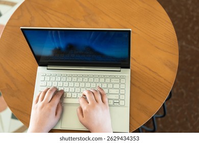 Business Professional Working on Laptop in Café