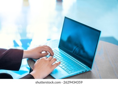 Business Professional Working on Laptop in Café