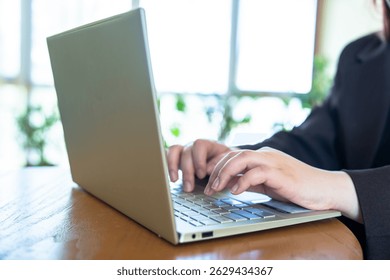 Business Professional Working on Laptop in Café