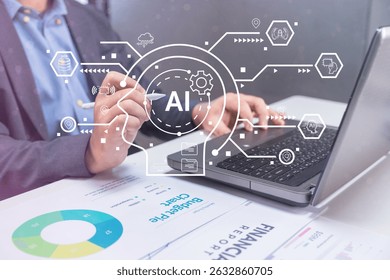 Business professional working on a laptop with artificial intelligence (AI) graphics overlay and financial charts on the desk.