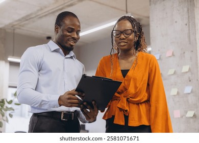 Business professionals analyzing documents together at modern workplace, collaborative teamwork in progress - Powered by Shutterstock - Get 15% off with code: PIKWIZARD15