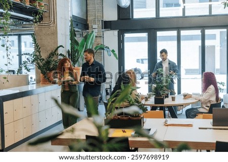 Business professionals collaborating and discussing ideas in a vibrant, plant-filled office, creating a productive, eco-friendly space