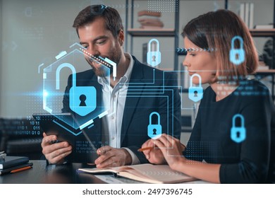 Business professionals discussing cybersecurity. Digital lock graphics overlay. Office setting. Concept of data protection and information security - Powered by Shutterstock