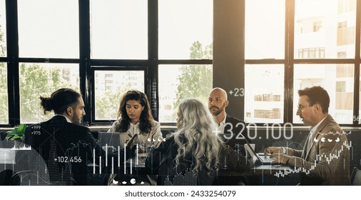 Business professionals in a meeting at a large table in an office with large windows, discussing over laptops with digital financial charts and data overlay, panorama. Work, successful business - Powered by Shutterstock