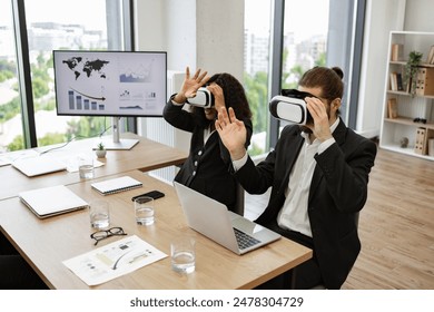 Business professionals in modern office using virtual reality headsets during meeting. Concept of innovative technology, digital transformation, teamwork, and future of work. - Powered by Shutterstock