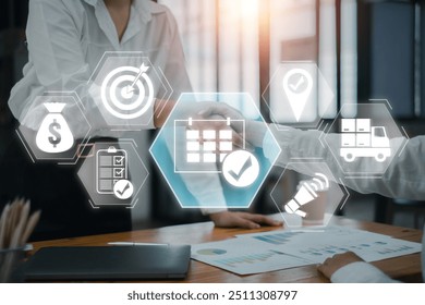 Business professionals shaking hands with event management icons overlay, symbolizing planning, strategy, and successful execution in a modern office environment.