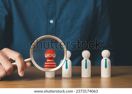 business protection, cybersecurity, cybercrime and hacker concept.businessman holding magnifier and searching wooden of thief hacker in business team.