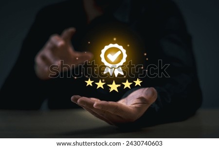 Business Quality Achievement and Excellence Concept. Businessman showcases a glowing five-star rating and award badge, symbolizing high quality and excellence in business.