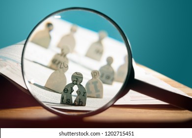 Business Recruitment Or Hiring Photo Concept. Looking For Talent. Icons Of Candidates Are Standing On Open Newspaper Under Magnifier.